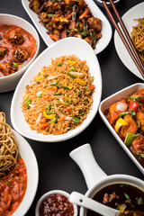Assorted Indo chinese dishes in group includes Schezwan/Szechuan hakka noodles, veg fried rice, veg manchurian, american chop suey, chilli paneer, crispy vegetable and vegetable soup