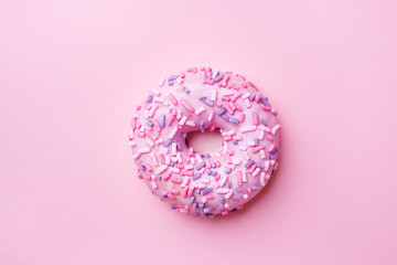 Pink doughnut on a pink background. Top view Flat lay.