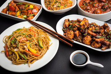 Assorted Indo chinese dishes in group includes Schezwan/Szechuan hakka noodles, veg fried rice, veg manchurian, american chop suey, chilli paneer, crispy vegetable and vegetable soup