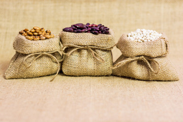 Fototapeta na wymiar Different kinds of hemp sack in a jute bag on a background of burlap. Food photography. Various types of beans. Minimalist photography.