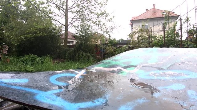 SLOWMO Rain falls on destroyed car in Metelkova city
