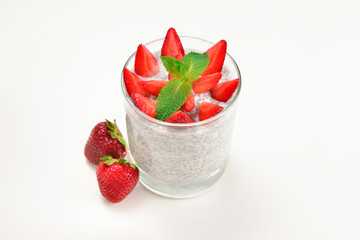 Chia pudding with strawberry and mint on a white background. Space for text or design.