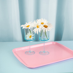Flowers in glasses on serving tray