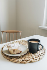 Morning breakfast with coffee with milk and cake on white table. Minimal food concept.