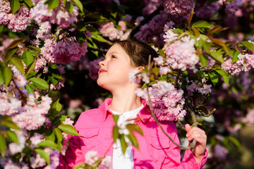 blossom smell, allergy. small girl child in spring flower bloom. skincare spa. Natural cosmetics for skin. happy girl in cherry flower. Sakura tree blooming. summer. Childhood beauty. Happy moments