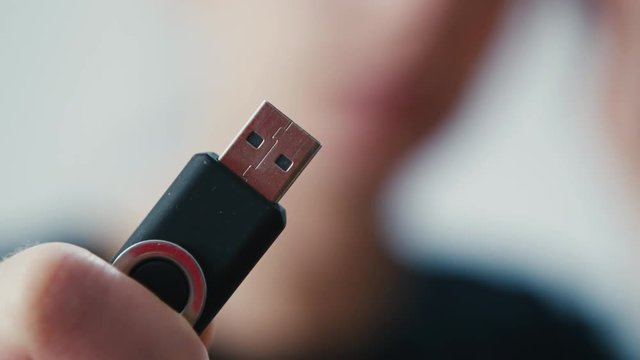 Choice of memory pendrive small disk held in hand, extreme close up shot