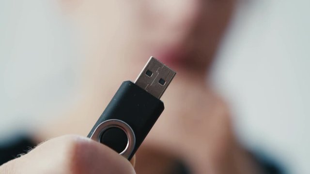 Pen drive storage technology disk held in hand, depth of field shot
