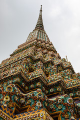 Side view of the pagodas of a temple in Bangkok with cloudy sky as background