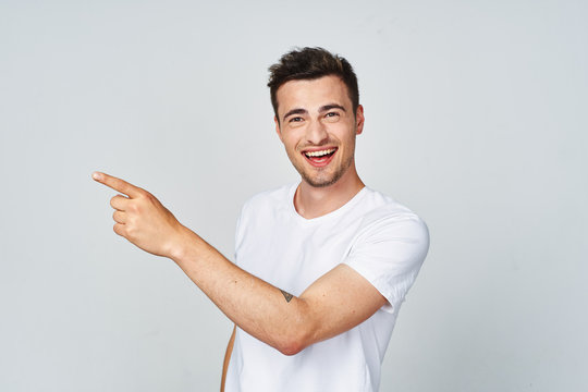 Young Man Pointing At Something Interesting