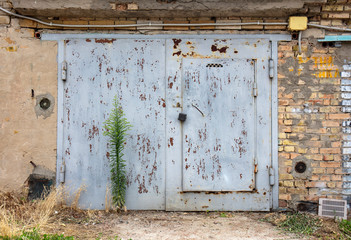 old metal door to the car garage
