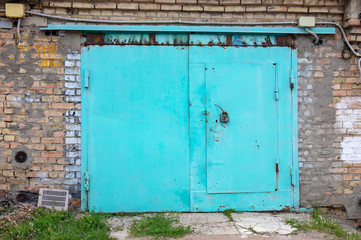 Fototapeta na wymiar old metal door to the car garage