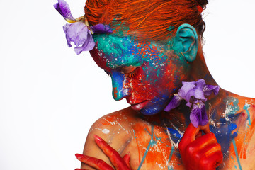 Creative fantastic makeup using colorful paints on the model