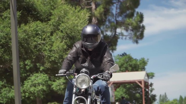 Slow Motion of Motorcyclist Riding With Leather Jacket