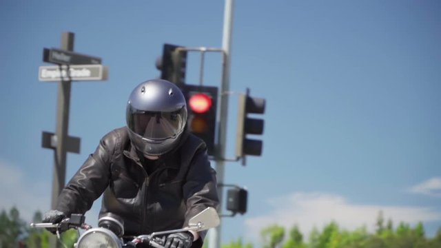 Slow Motion of Motorcyclist Riding With Leather Jacket