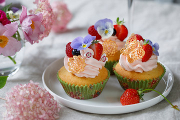 Cupcake decorated with buttercream, fruits and flowers