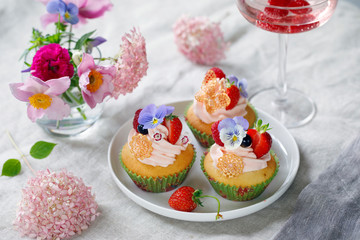 Cupcake decorated with buttercream, fruits and flowers