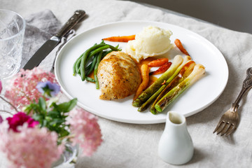 Roast dinner with chicken, baby leeks, carrots, green beans and potato mash