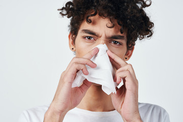 young woman blowing her nose