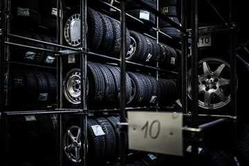 Obraz na płótnie Canvas Tyres being stored in a garage - waiting for the client to have them put on his car