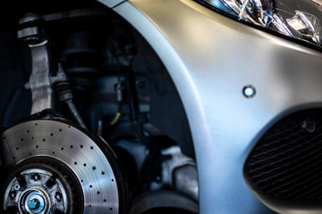 Car in a garage for maintenance, oil/tyre change (shallow DOF; color toned image)