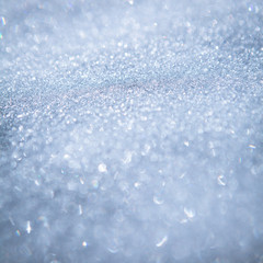 Snowy background - texture of white snow sparkling in the sun