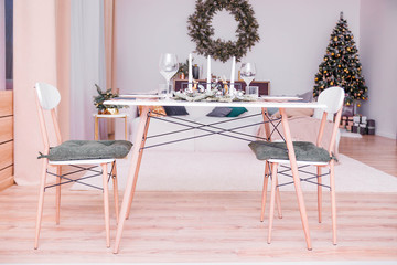 Table setting in the New Year's style. Simple and stylish interior rooms in the New Year's style