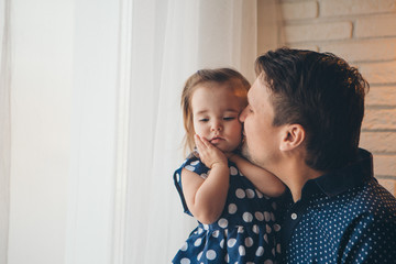 Dad holds the baby in his arms. The concept of educating the father of young children, Happy childhood, a friendly family.