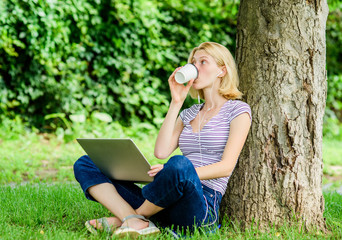 Reasons why you should take your work outside. Nature is essential to wellbeing and ability to be productive. Girl work with laptop in park. Lunch time relax or coffee break. Work in summer park