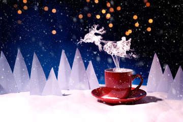 Steam in reindeer and Santa Claus into sled shape flying over red mug of coffee or tea in snowy landscape. Christmas or New Year celebration concept. Copy space