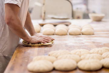 bakery worker preparing the dough