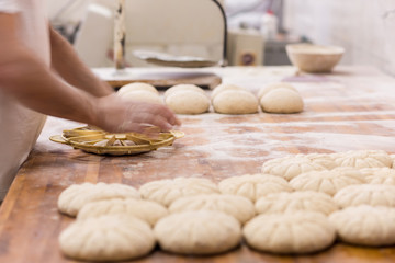 bakery worker preparing the dough