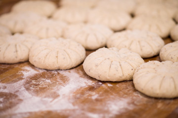 balls of dough bread getting ready to be baked