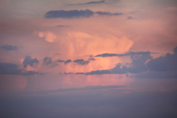 Background and texture of a sky with clouds in blue and pink colors.