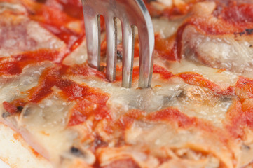 A delicious homemade pizza on a plate isolated on a white background. Pizza on a plate with a knife...