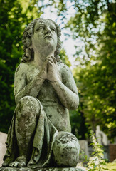 Marble statue and an ancient abandoned Gothic cemetery