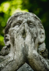 Marble statue and an ancient abandoned Gothic cemetery