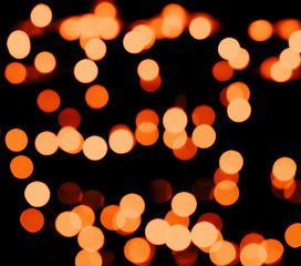 Abstract defocused glittering background. Blurry bokeh of night golden lights. Christmas and holiday concept