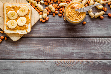 sandwiches with peanut butter and banana for breakfast on wooden background top view space for text