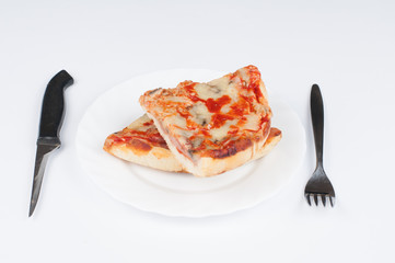 A delicious homemade pizza on a plate isolated on a white background. Pizza on a plate with a knife and a fork
