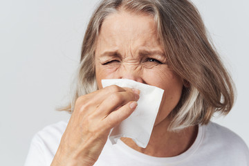 sick woman blowing her nose