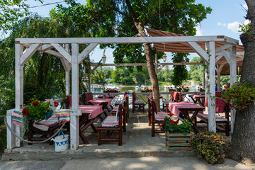 Fototapeta na wymiar Novi Sad, Serbia July 16, 2019: Fishing island Ribarac and a restaurant on the Danube river.