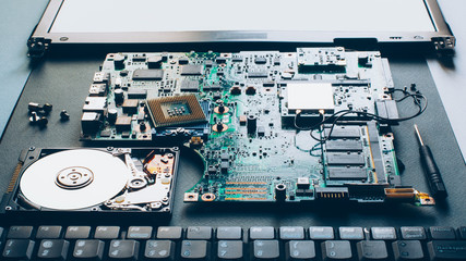 Laptop repair. Disassembled computer parts. PC electronic components. Closeup of keyboard, hdd,...