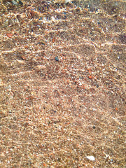 pebbles through the shallow clear water