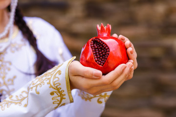a large plastic red garnet in women's hands