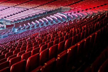 Fototapeta premium Vacant red chairs of stadium stand