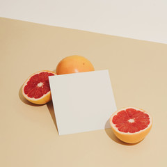 Minimal sunlit fruit composition with sand colour background and sharp shadows. Summer creative copy space.