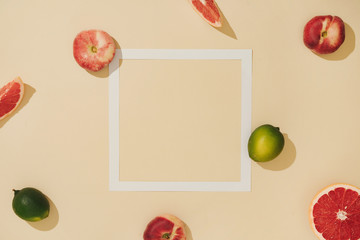 Minimal sunlit fruit composition with sand colour background and sharp shadows. Summer creative copy space.