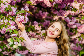 Spring is in my heart. happy girl in cherry flower. Sakura tree blooming. blossom smell, allergy. skincare. Natural cosmetics for skin. summer. Childhood beauty. small girl child in spring flower