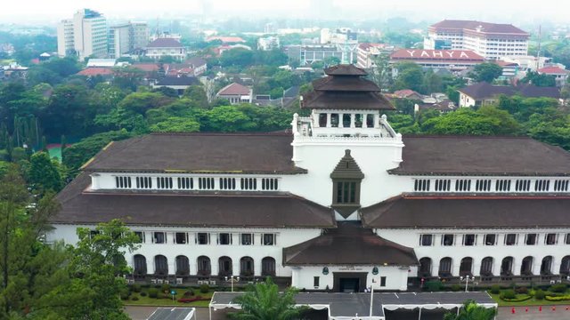 BANDUNG, Indonesia - July 03, 2019: Aerial scenery of Gedung Sate or Satay Building in Bandung city, West Java. Shot in 4k resolution from a drone flying from left to right