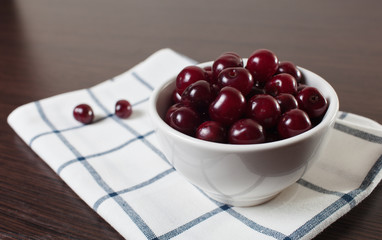 Bowl of сherries on a table.Copy space